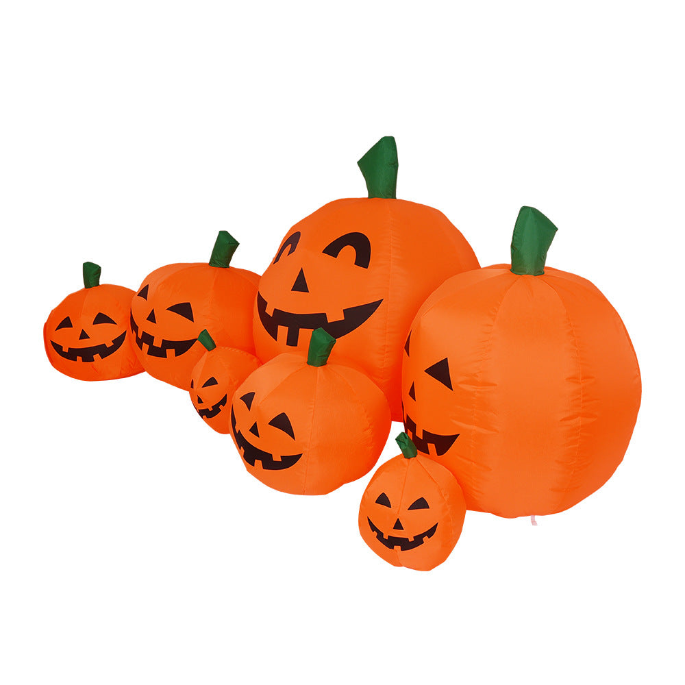 Six inflatable pumpkins with smiling jack-o'-lantern faces sit in a row. The pumpkins vary in size, all with orange bodies and green stems, creating a festive Halloween display.