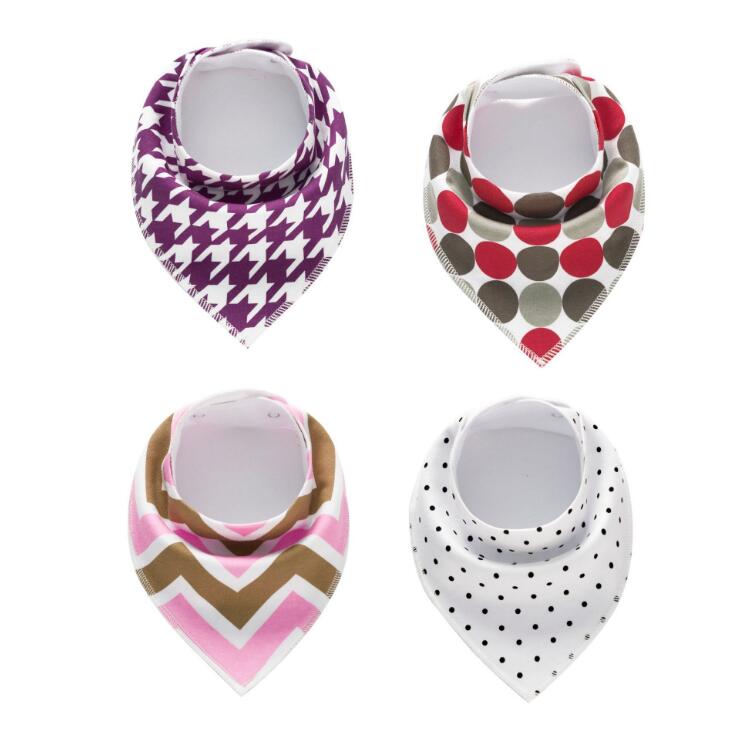 Four bandana bibs with different patterns: purple houndstooth, red and gray polka dots, pink and brown chevron, and white with black polka dots.