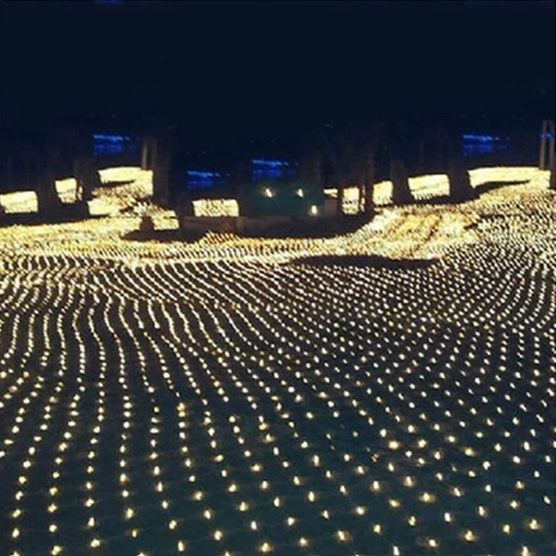 Thousands of small lights create wavy patterns on a dark field, resembling a sea of glowing stars under a night sky.