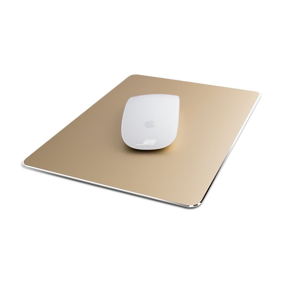 White computer mouse placed on a metallic gold rectangular mousepad with rounded corners, positioned on a plain white background.