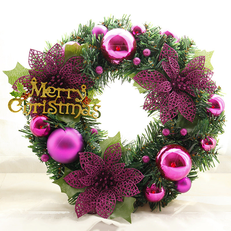 Festive Christmas wreath adorned with shiny purple baubles, lace-like poinsettias, and lush green foliage. A "Merry Christmas" sign adds a cheerful holiday greeting.
