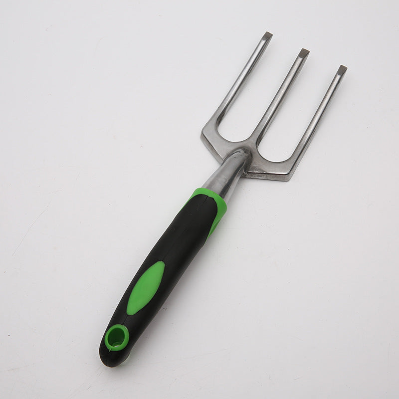 A gardening hand fork with three metallic prongs and a black handle featuring green accents, designed for comfortable gripping, laid on a white background.