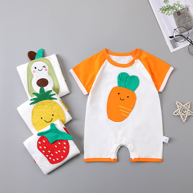 Baby romper with orange sleeves featuring a cute carrot design. Nearby, folded onesies with avocado, pineapple, and strawberry prints are stacked. A small star decoration is visible.