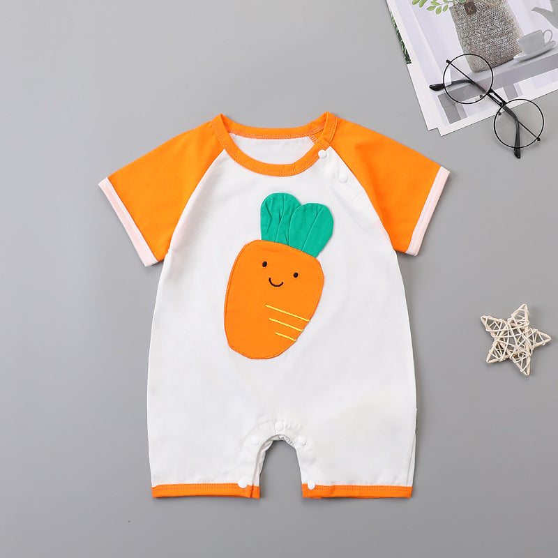White baby romper with orange sleeves and trim, featuring a cute smiling carrot design on the front. Nearby are round glasses, a magazine, and a decorative star.