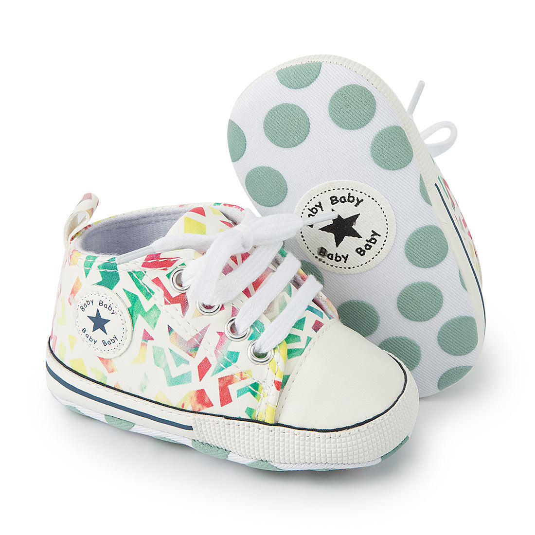 Colorful baby sneakers with geometric patterns, white laces, and a soft sole featuring green polka dots. A star logo with "Baby Baby" appears on the side.