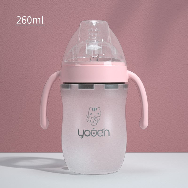 Pink baby bottle with handles, 260ml capacity, features a cute cartoon cat. Transparent lid on a matte finish backdrop. Suitable for infants and toddlers.