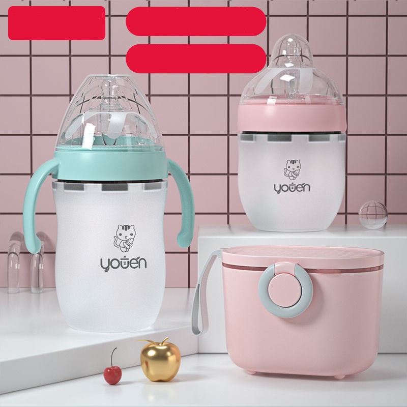 Three baby bottles with cute animal designs, two with handles, are displayed on a tiled pink background. A pink lunch container and decorative cherries and apple are also visible.
