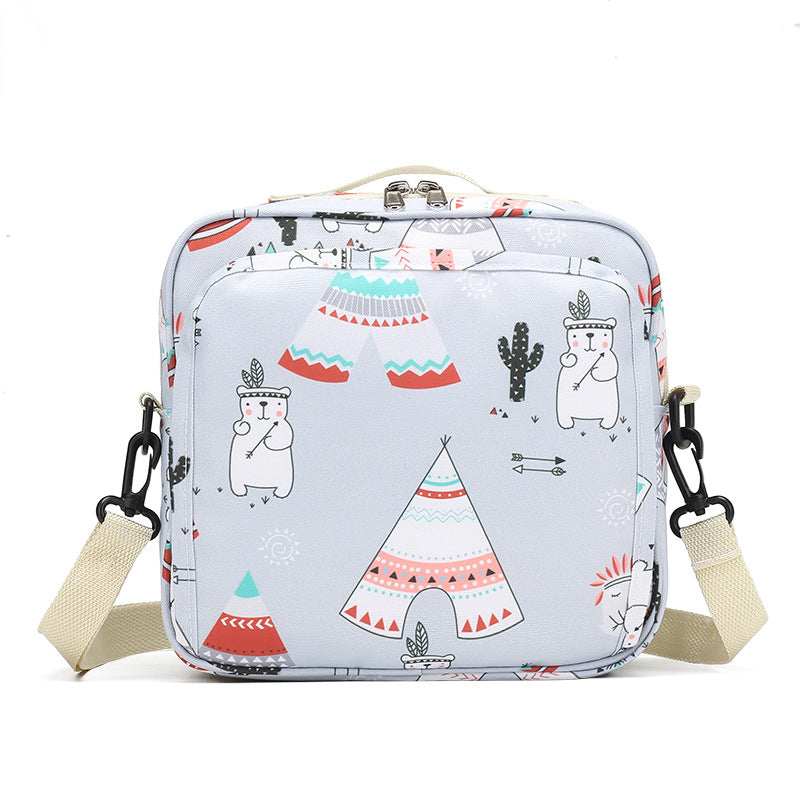 Cute square bag with cartoon designs of bears, teepees, arrows, and cacti. The bag features a beige strap and a pastel color scheme with accents of red, teal, and pink.