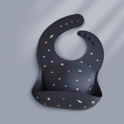 A dark bib with adjustable snap buttons, featuring colorful polka dots and a convenient front pocket for catching spills.