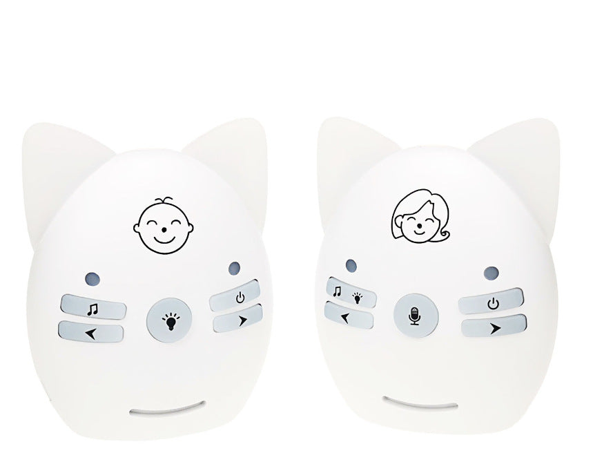 Two white baby monitors resembling cat faces, with ears on top. The left has a baby icon, the right has a parent icon. Each features buttons for music, power, and other functions.