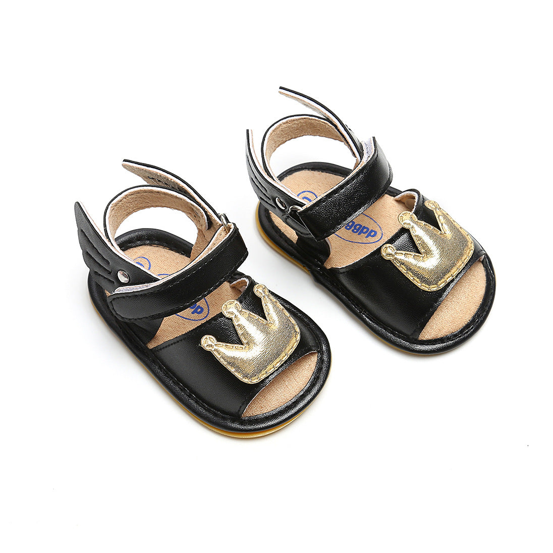 Black toddler sandals with open toes and adjustable straps, featuring decorative gold crown embellishments on the front.