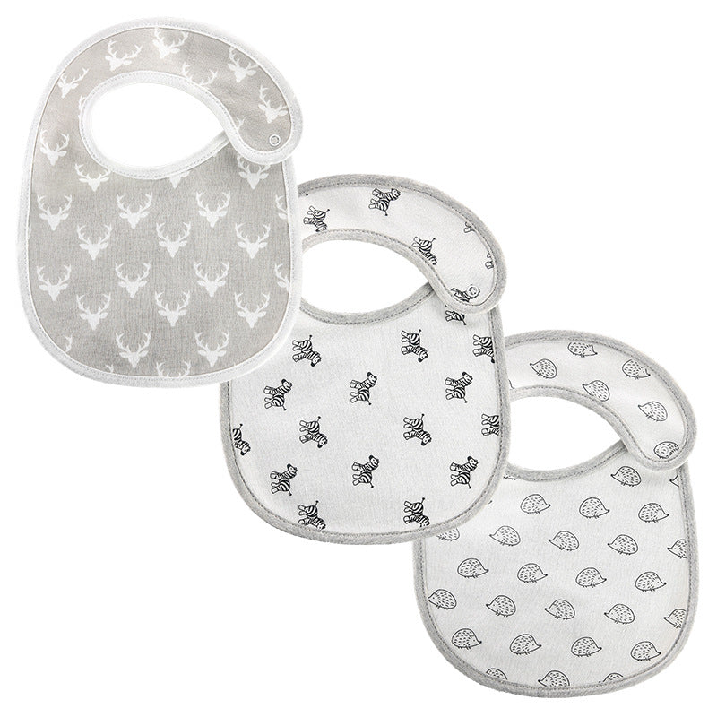 Three baby bibs in soft gray tones, each with different prints: deer heads, bees, and hedgehogs. They have snap closures and a rounded shape for easy wear.