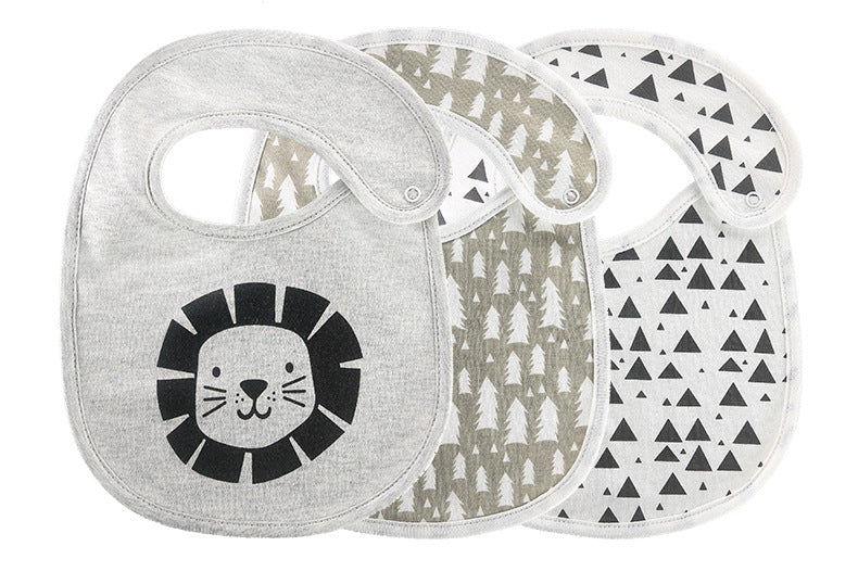 Three baby bibs with button fastenings, featuring a lion face, tree pattern, and black triangles on a white background, arranged in a fan-like display.