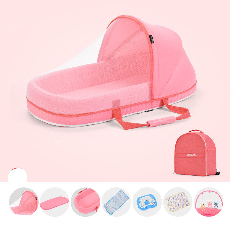 Pink portable baby crib with canopy and handles, displayed with a matching carrying bag. Below are circular images showing parts and accessories like a cushion, blanket, and toys.