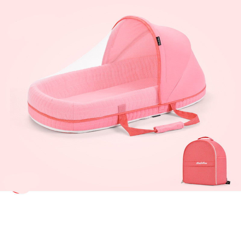 Pink portable baby bed with a canopy and carry handles, designed for convenient travel. It is shown folded into a compact backpack on a light pink background.