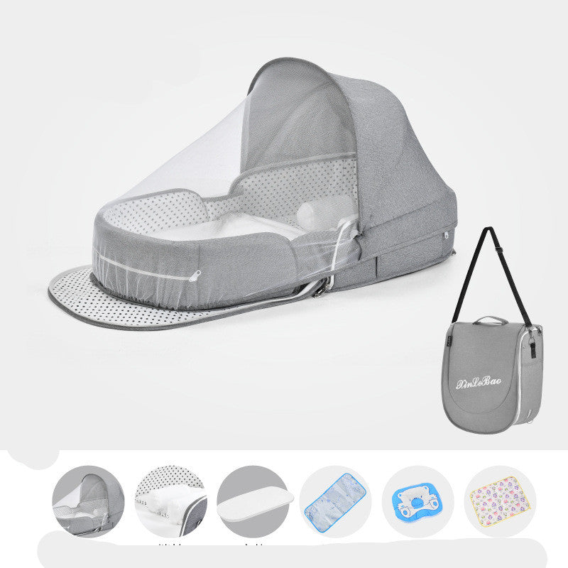 Gray portable baby crib with a canopy and mesh cover, includes a matching carrying case with a shoulder strap. Various accessory options are displayed below.