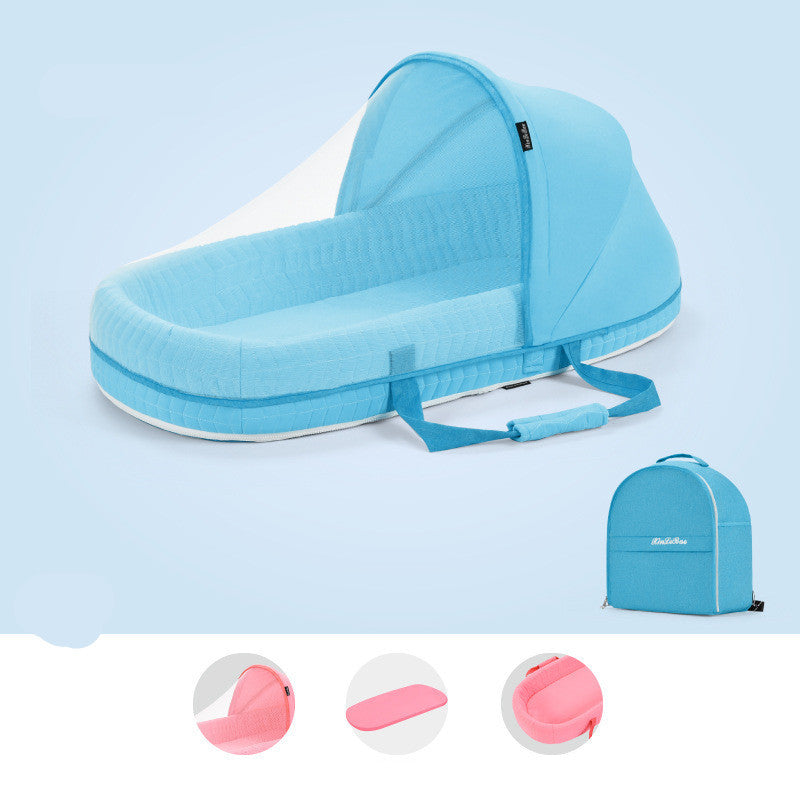 Light blue portable baby crib with a foldable canopy, carrying handles, and a pink mattress. Includes a matching compact backpack for easy transport.