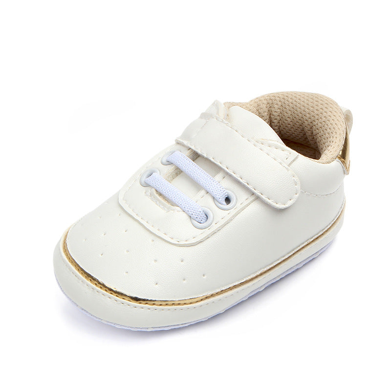 White baby shoe with blue laces and velcro strap. Features stitched details, perforated design, and beige cushioned interior. Suitable for infants, blending style and comfort.