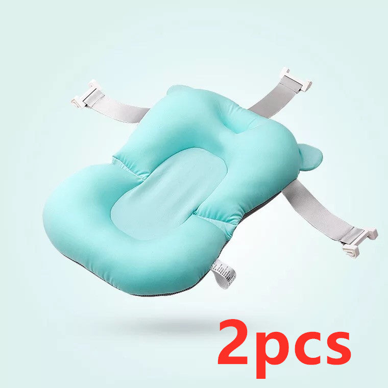 A turquoise baby bath cushion with adjustable straps and soft padding against a light background. The text "2pcs" is displayed in bold red font at the bottom right.