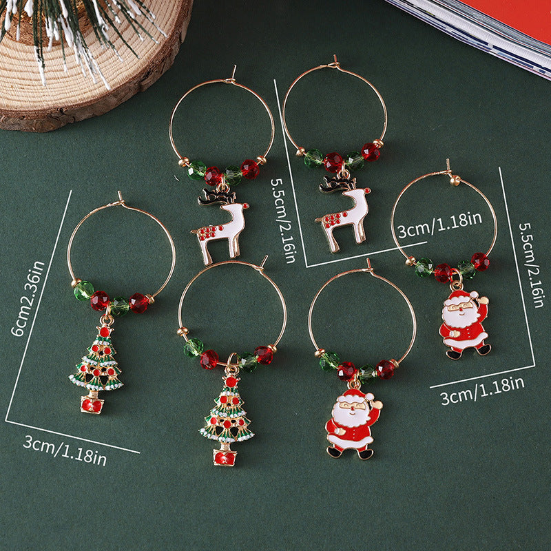 Six Christmas-themed drink charms on a dark surface, featuring reindeer, Santa, and tree designs. Sizes are marked with dimensions ranging from 2.36in to 1.18in.