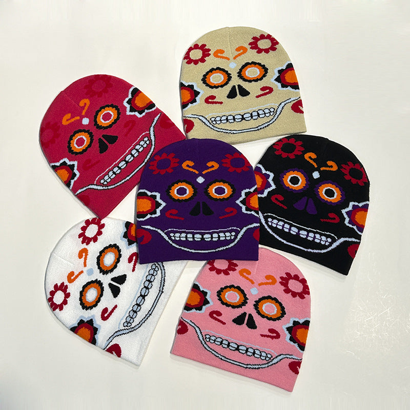Six colorful beanies with Day of the Dead skull designs, featuring vibrant flowers and ornate patterns, arranged in a circular pattern on a white background.