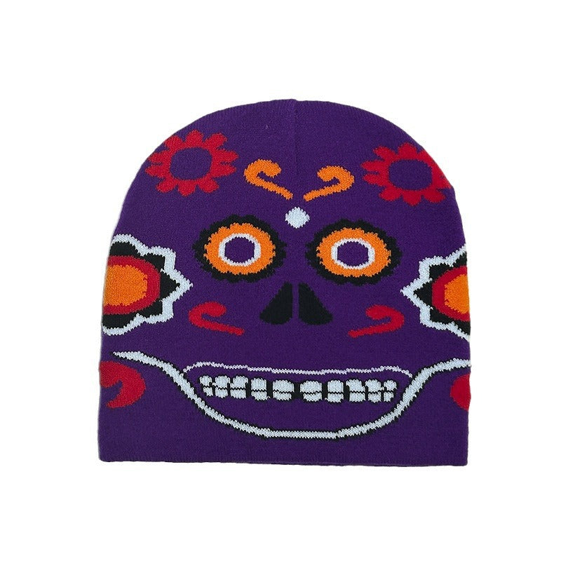 Purple beanie with a colorful sugar skull design featuring vibrant red, orange, and white patterns, including flowers and a smiling face.