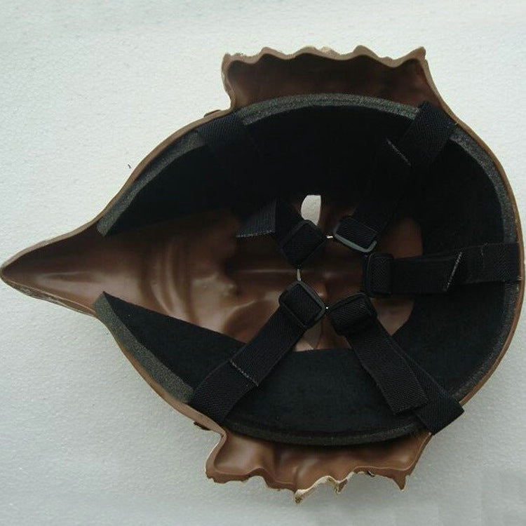Back view of a brown, shell-shaped helmet with black padding and adjustable straps inside, designed for a comfortable fit. The shell has a textured, wavy edge.