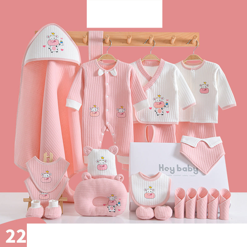 Pink and white baby clothing set with cow designs, includes onesies, hats, bibs, a blanket, a plush pillow, and socks, all displayed neatly with "Hey Baby" packaging.