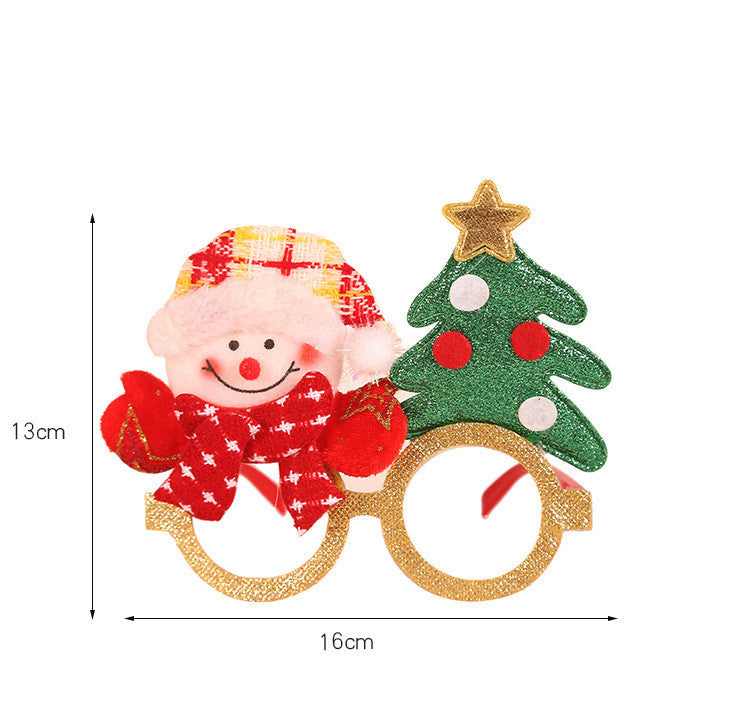 Festive glasses featuring a smiling snowman with a red scarf and hat on one side, and a glittery green Christmas tree with a gold star on the other. Dimensions: 13x16 cm.