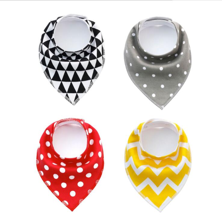 Four baby bandana bibs in different patterns: black triangles on white, gray with white polka dots, red with white polka dots, and yellow with white chevrons.