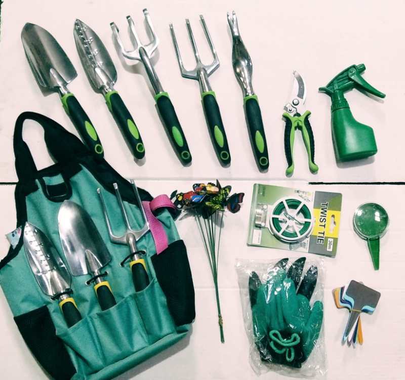 Gardening tool set including trowels, hand rakes, shears, spray bottle, gloves, twist tie, and a turquoise carrying bag, arranged neatly on a white surface.