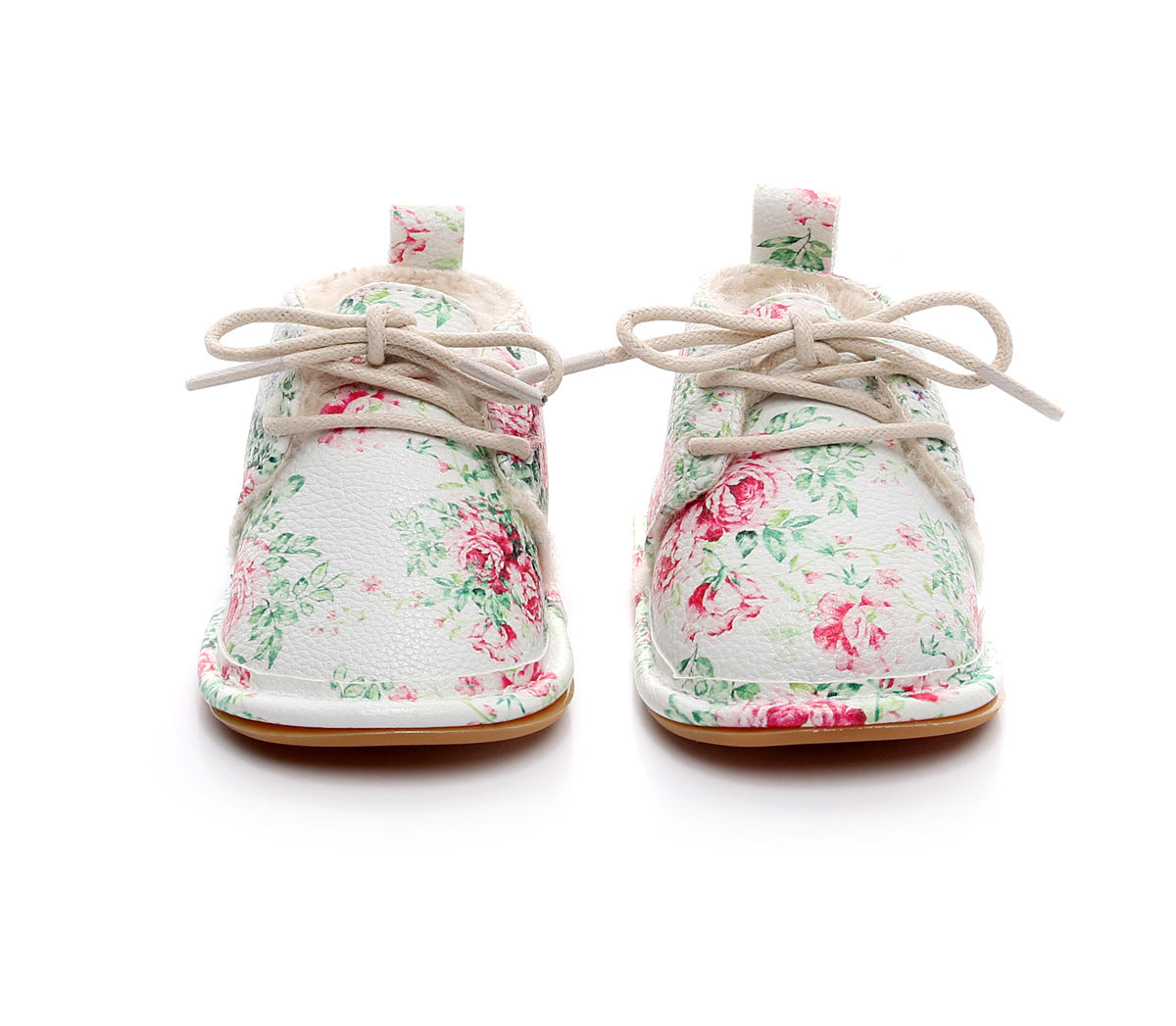 Floral-patterned baby shoes with soft beige laces and a plush lining against a white background. The shoes feature pink and green rose designs, creating a delicate, charming appearance.