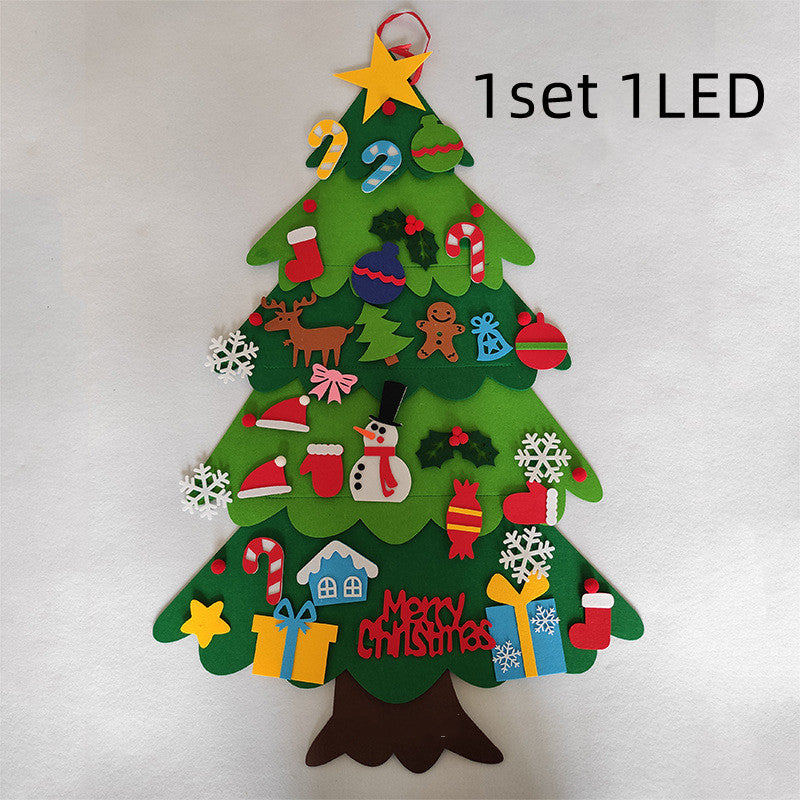 Felt Christmas tree with various colorful decorations including candy canes, snowflakes, presents, a snowman, and "Merry Christmas" text. A star tops the tree.