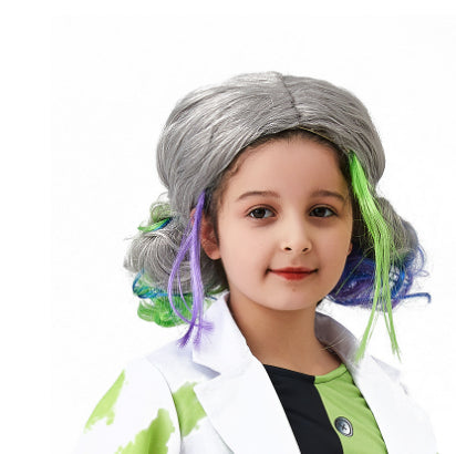 Child in a white lab coat and colorful wig with gray, green, and purple hair strands, smiling against a blank background.
