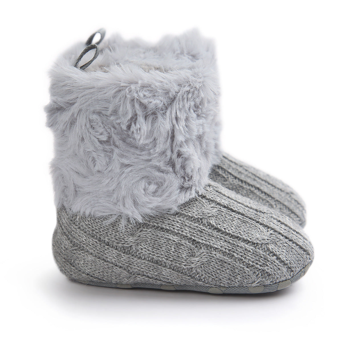 Gray knitted baby booties with a cable pattern, featuring a soft, fluffy faux fur cuff and small loop handles at the back.