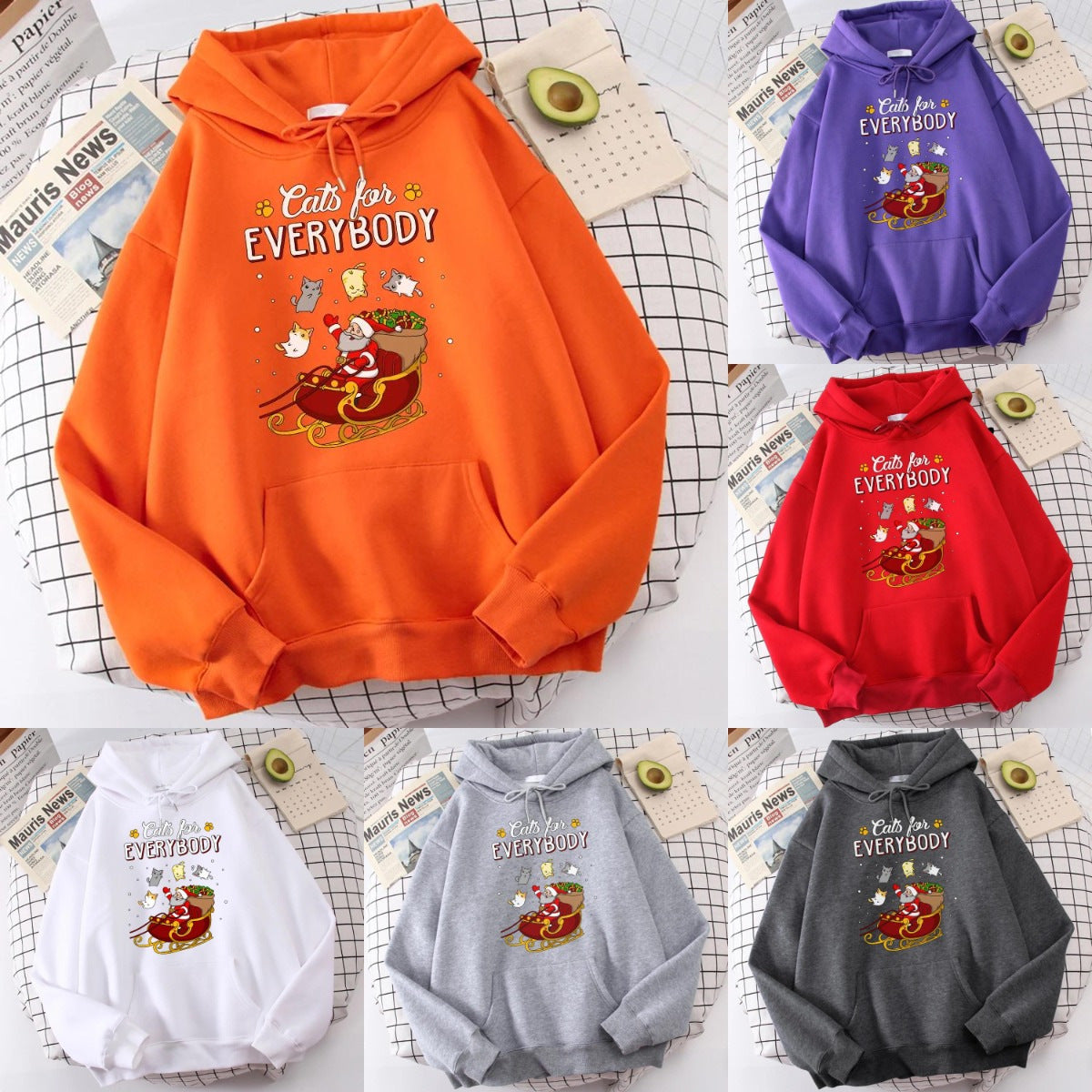 Six colorful hoodies with the phrase "Cats for Everybody" and a Christmas-themed illustration of a cat in a sleigh. Hoodies are orange, purple, red, white, gray, and dark gray.