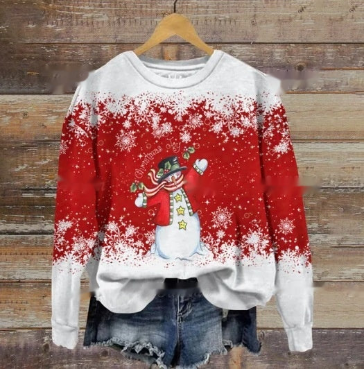 A festive red and white sweater with a snowman design, snowflakes, and "Merry Christmas" text, paired with denim shorts. It hangs on a wooden background.