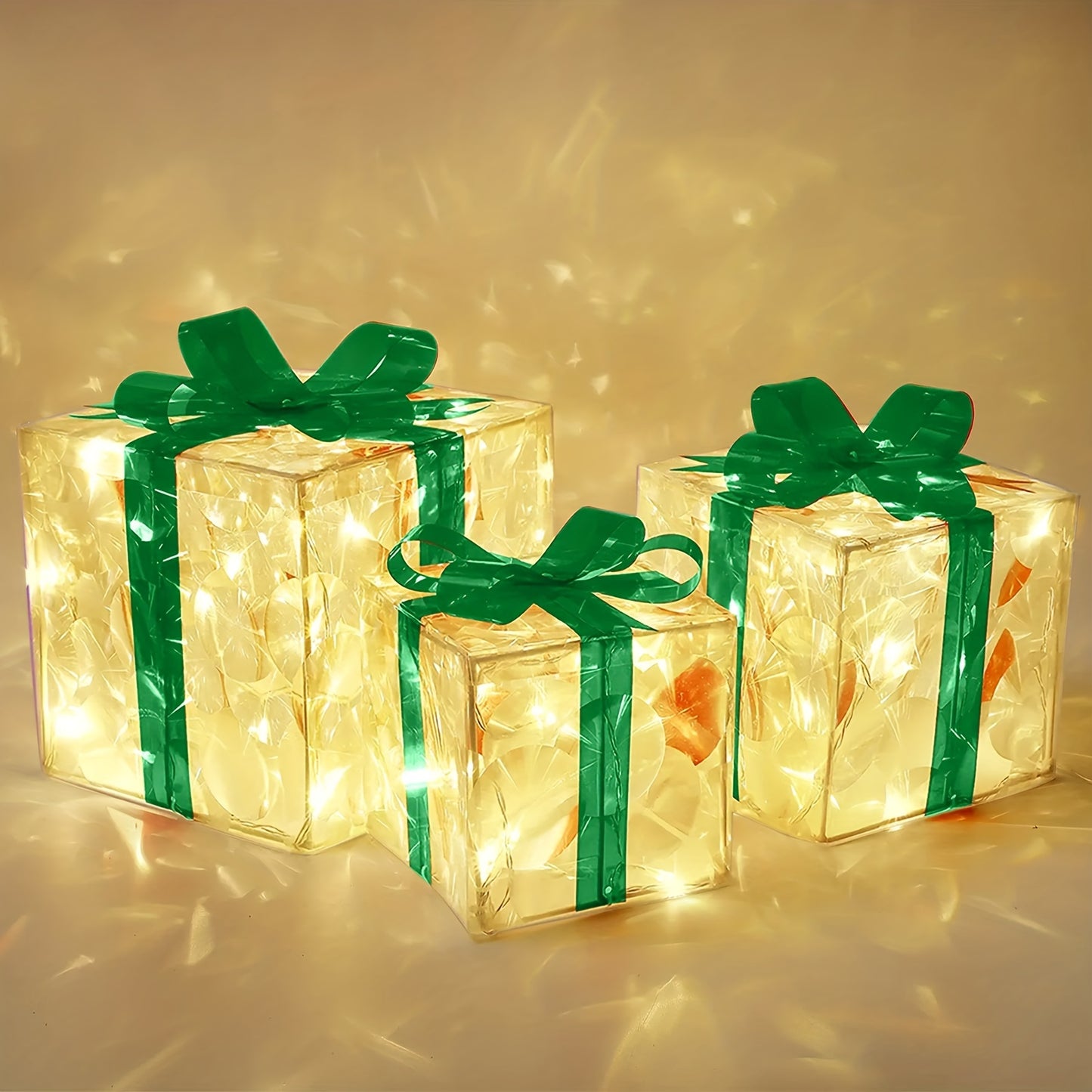 Three illuminated gift boxes in varying sizes decorated with shiny green ribbons and bows. The boxes emit a warm glow, casting soft patterns on the surrounding surface.