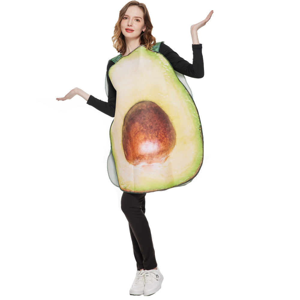 Person wearing a large avocado costume, featuring green skin and brown pit, with arms raised and smiling. Dressed in black with white sneakers against a plain background.