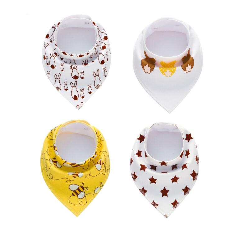 Four baby bibs are displayed: one with bunny patterns, one with acorns, one yellow with bees, and one white with red stars. Each bib has a triangular shape and snap closure.