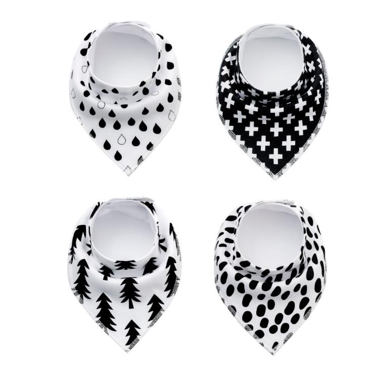 Four black and white baby bandana bibs with different patterns: raindrops, crosses, trees, and polka dots, arranged in a grid on a white background.