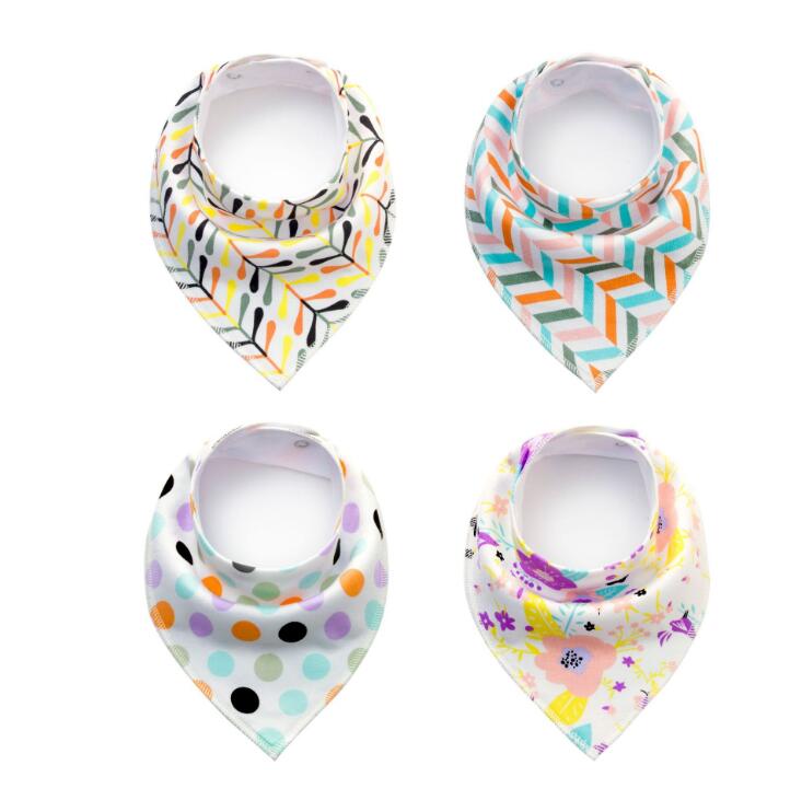 Four baby bandana bibs with different patterns: top left has leaf design, top right is zigzag, bottom left features colorful polka dots, and bottom right displays floral prints.