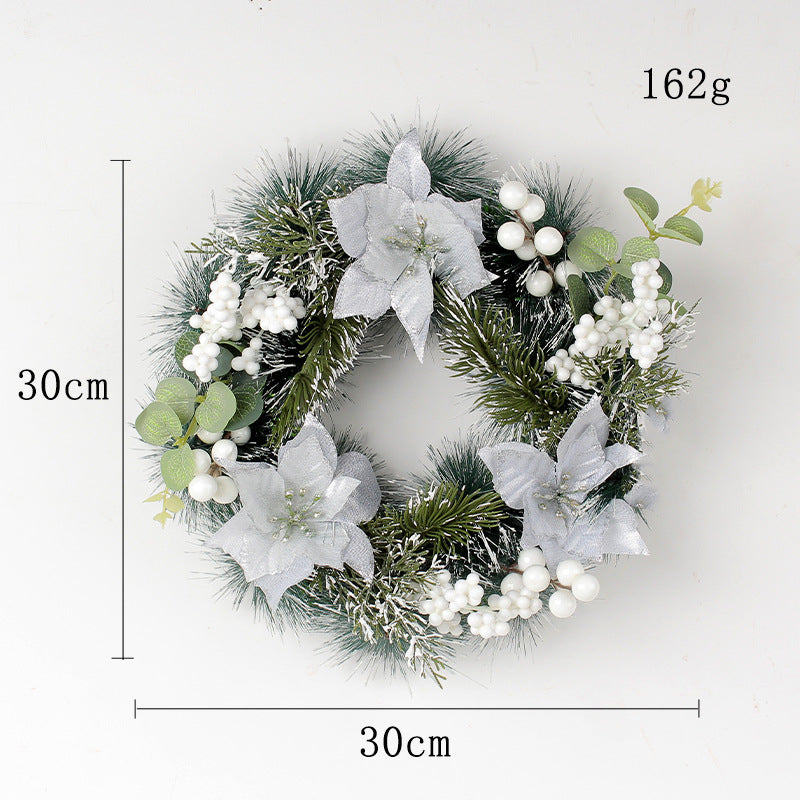 A 30cm Christmas wreath featuring green pine branches, frosted white berries, and silver poinsettias. Weighs 162g.
