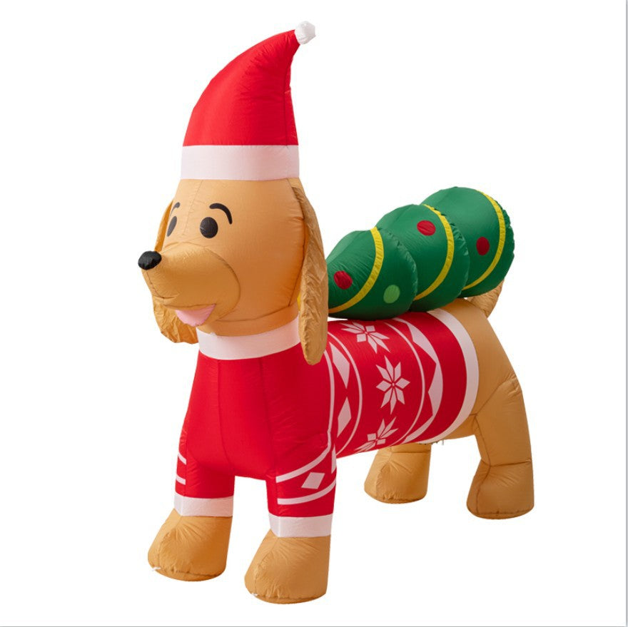 Inflatable dog wearing a Santa hat and red holiday sweater with snowflakes, carrying a green Christmas tree decorated with red ornaments on its back, placed on a white background.