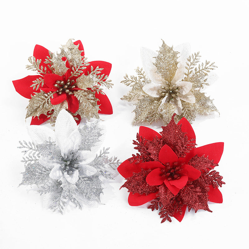Four decorative poinsettia flowers in red, gold, and silver, with glittery accents, arranged on a white background.