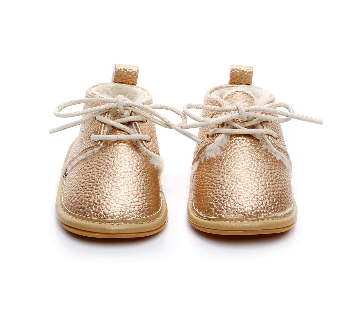 Gold baby shoes with a textured finish, white laces, and soft white fleece lining. The shoes have a sturdy tan sole and a small loop at the heel for easy pulling.