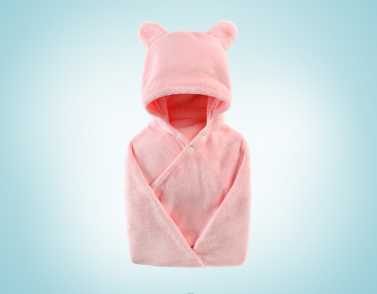 Soft pink baby blanket with a hood featuring bear ears. The blanket is folded neatly against a light blue background, highlighting its plush texture and wrap-around design.