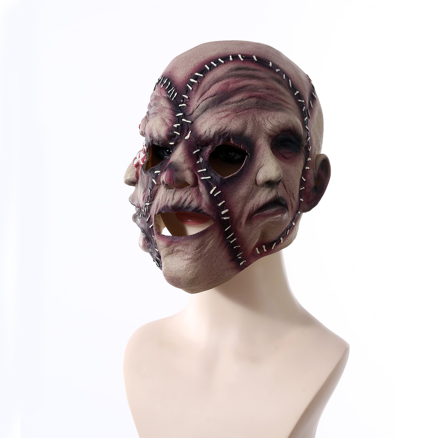 A macabre, stitched human face mask with multiple faces and visible seams on a mannequin head, conveying a creepy, horror-themed appearance against a plain background.