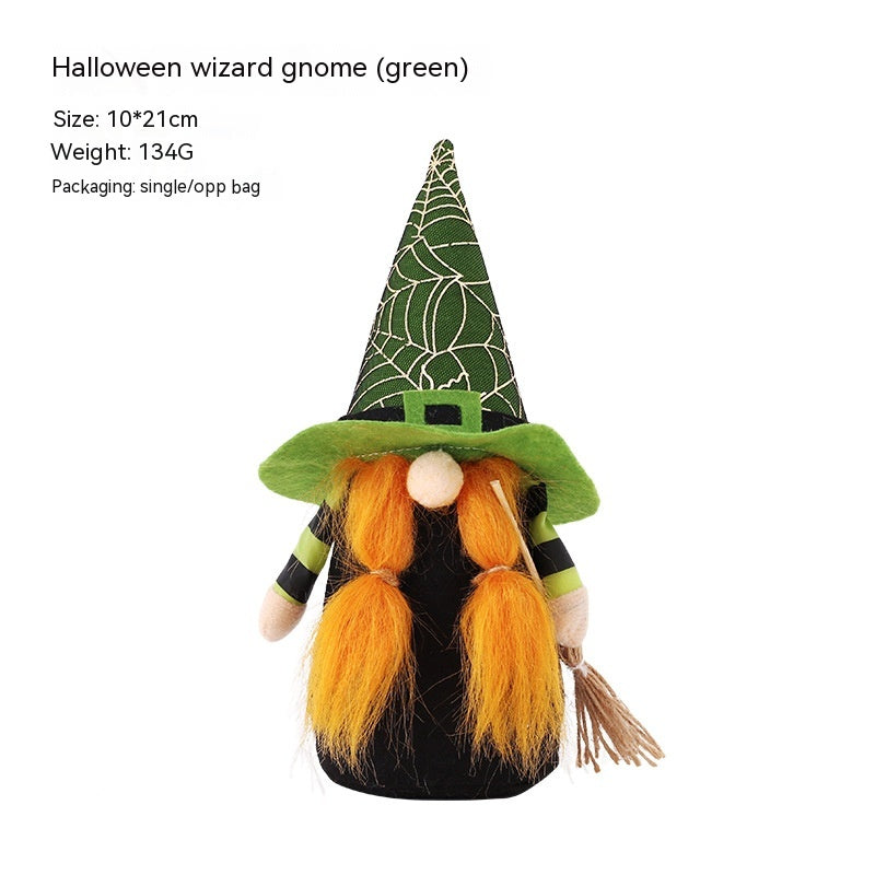 A Halloween-themed gnome with a green witch hat decorated with white spiderweb patterns. It has a round nose, orange beard, and green hat brim. Dressed in black with striped sleeves, the gnome holds a small broom. Dimensions are 10x21 cm, weighing 134g, and it comes in a single OPP bag.