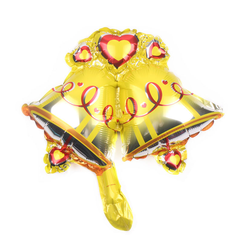 Golden balloon shaped like two wedding bells with red heart accents and swirling ribbon designs.